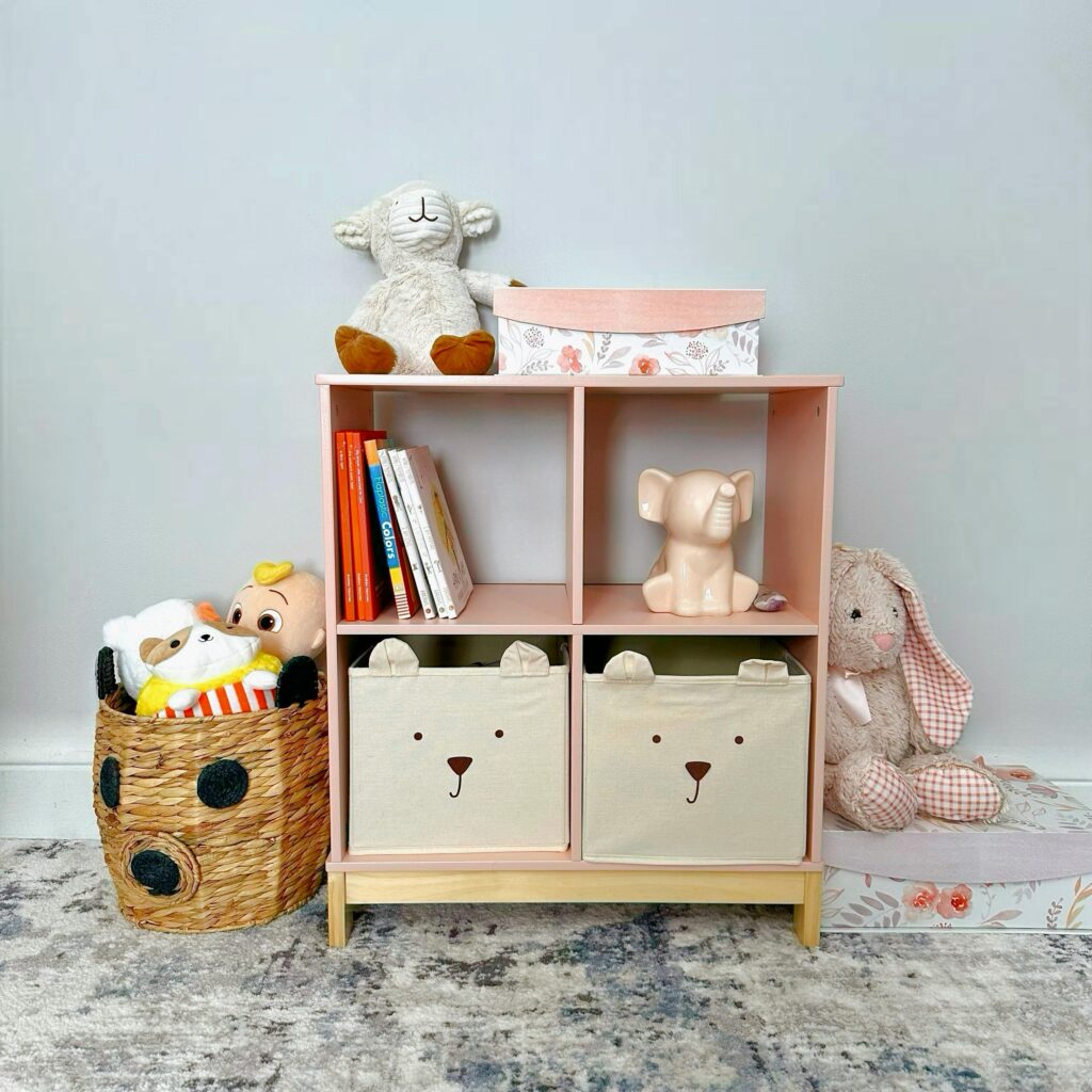 Organized playroom shelf with plush toys, books, and whimsical storage for children.